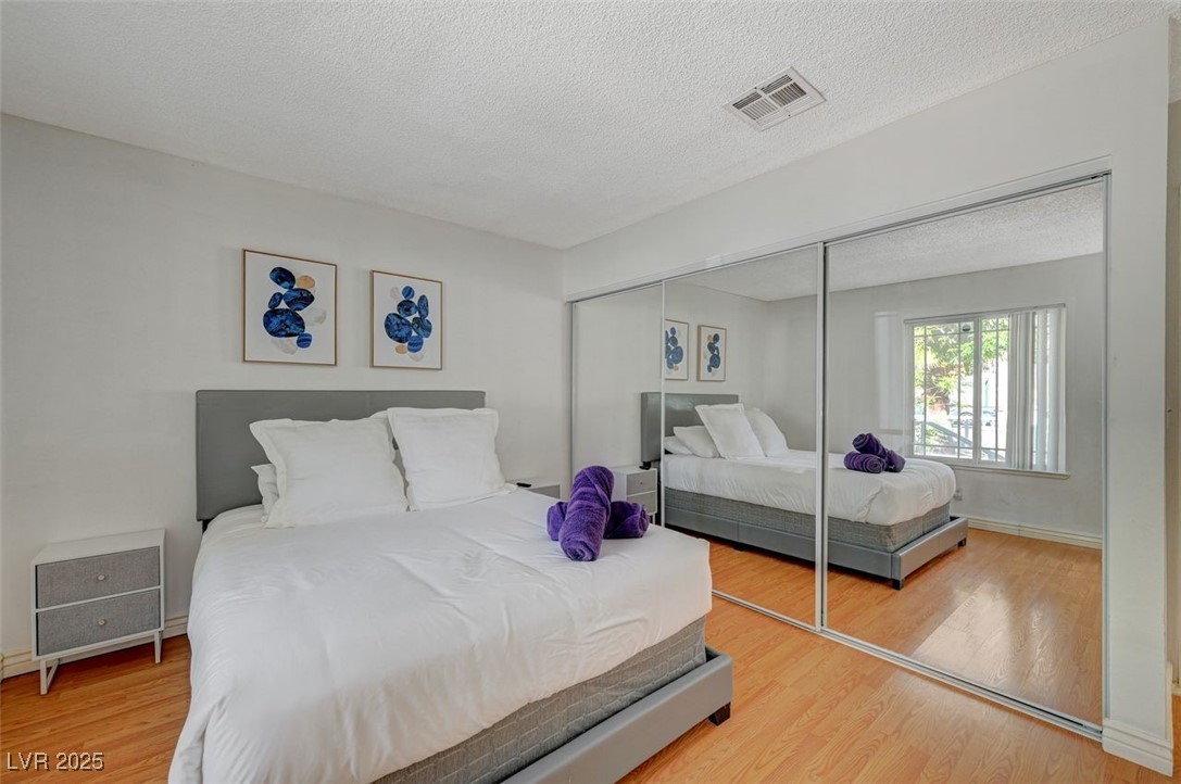 5248 Rambling Road Las Vegas, NV 89120 - Photo 25 of 35 Bedroom with a textured ceiling, light wood finished floors, and a closet