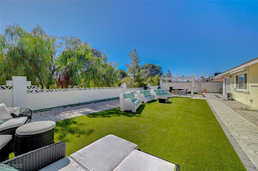5248 Rambling Road Las Vegas, NV 89120 - Photo 28 of 35 Fenced backyard featuring an outdoor hangout area and a patio