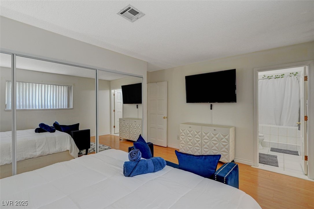 5248 Rambling Road Las Vegas, NV 89120 - Photo 29 of 33 Bedroom featuring wood finished floors, a closet, and ensuite bathroom