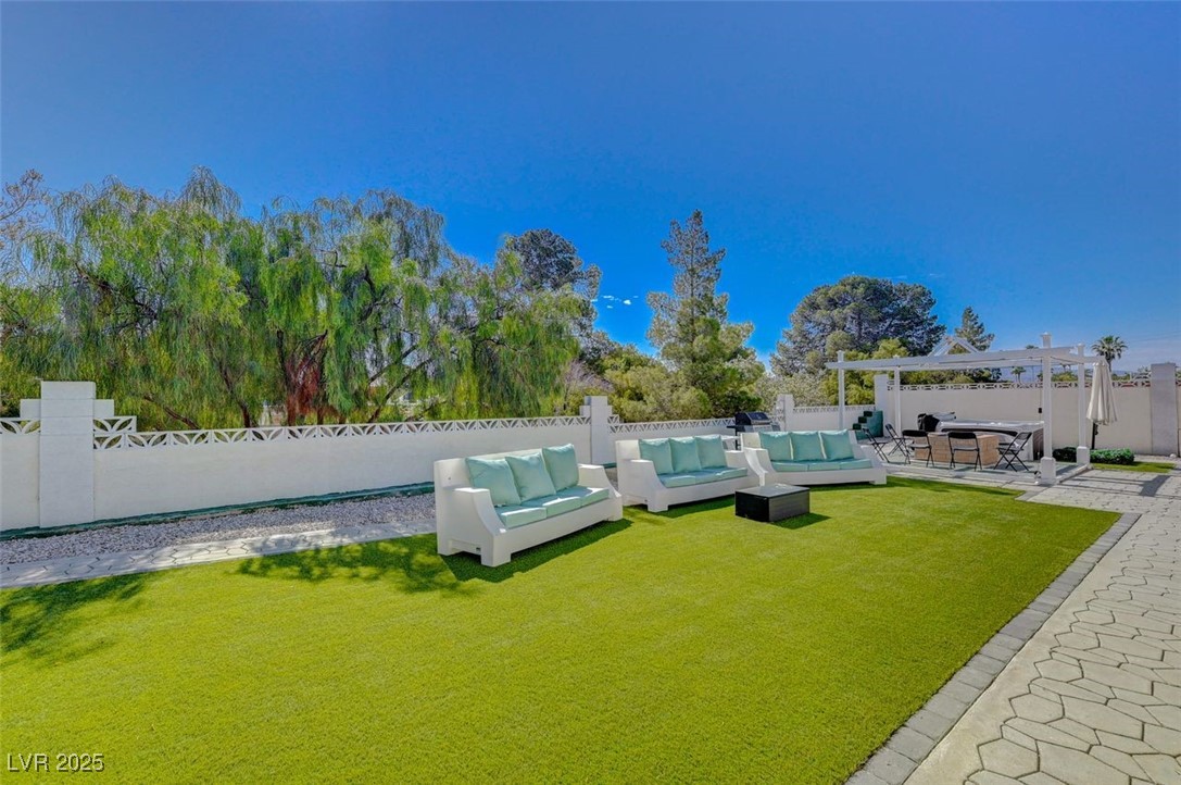 5248 Rambling Road Las Vegas, NV 89120 - Photo 32 of 35 Fenced backyard with outdoor lounge area, a patio area, a pergola, and a hot tub