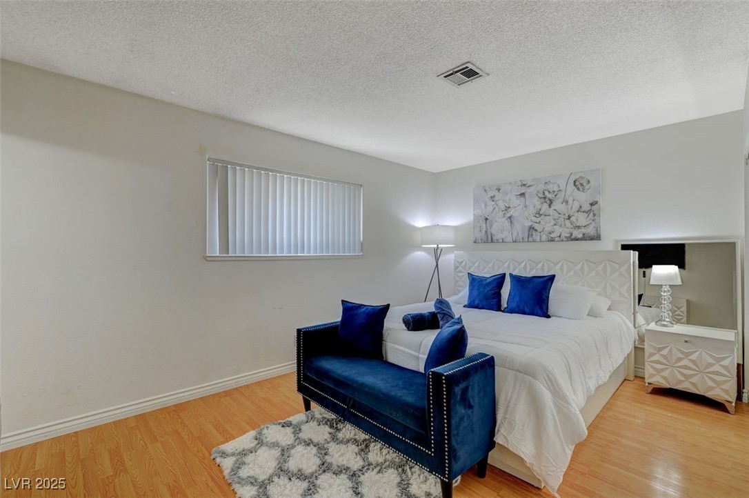 5248 Rambling Road Las Vegas, NV 89120 - Photo 33 of 35 Bedroom with a textured ceiling and light wood finished floors