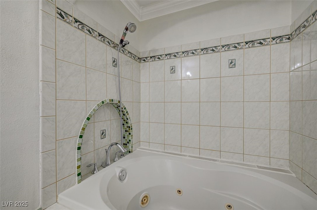 5248 Rambling Road Las Vegas, NV 89120 - Photo 34 of 35 Bathroom featuring crown molding and a jetted tub