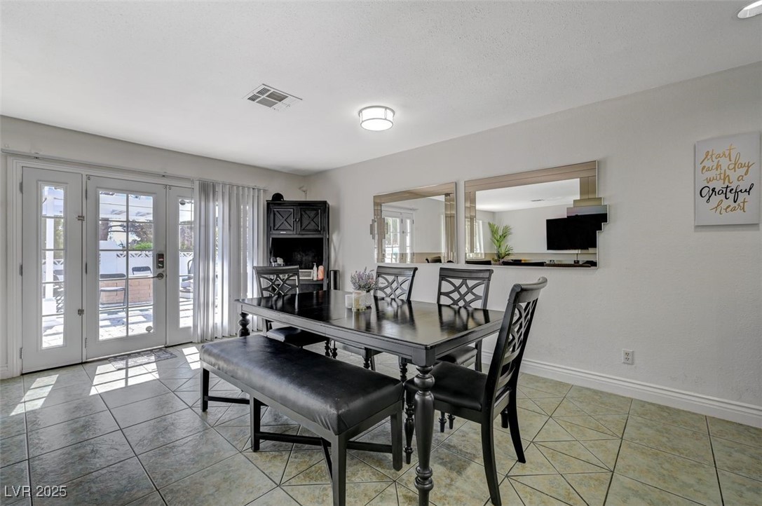 5248 Rambling Road Las Vegas, NV 89120 - Photo 5 of 33 Tiled dining space with healthy amount of natural light