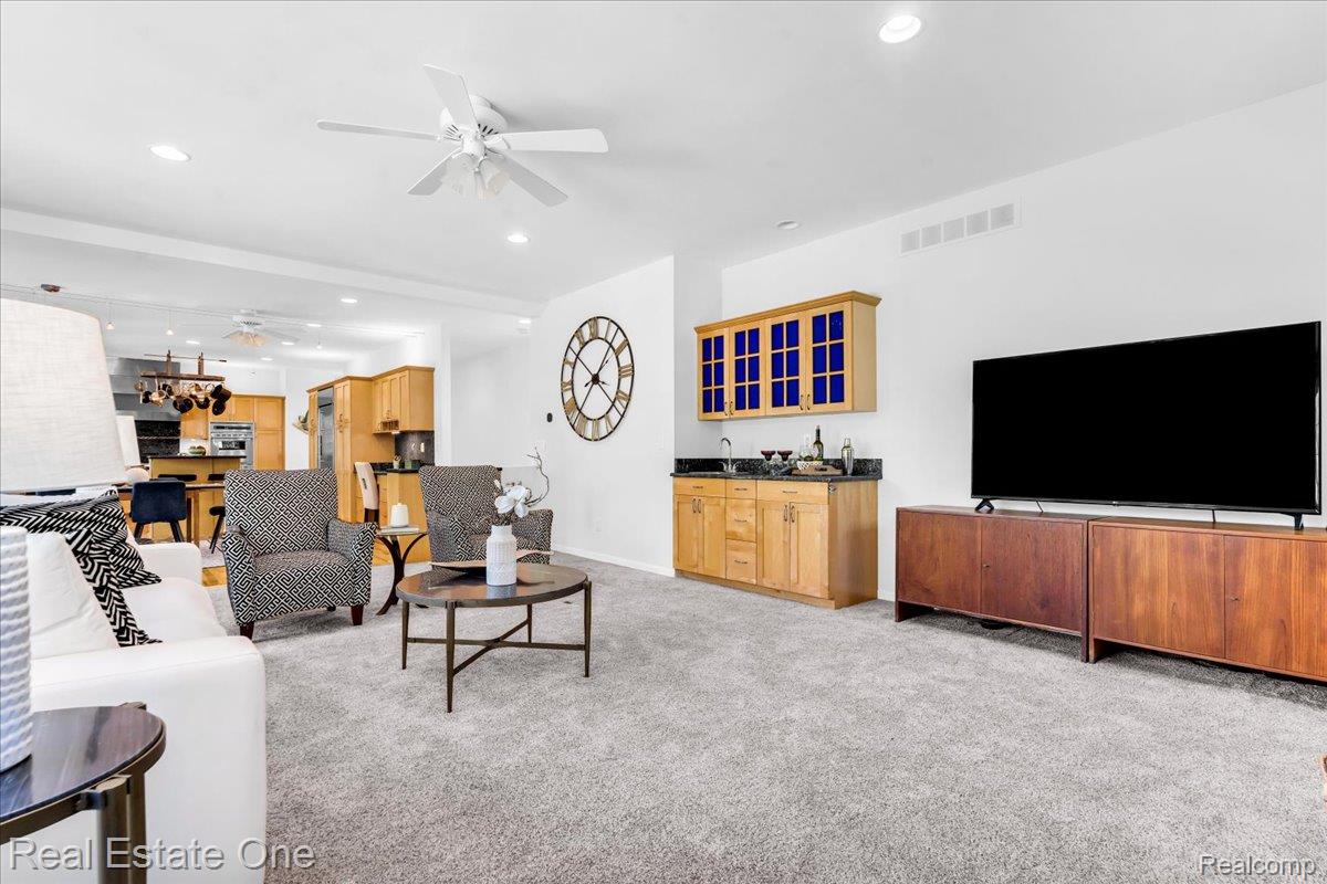 33850 Braebury Ridge Farmington, MI 48331 - Photo 13 of 85 Spacious living area featuring light-toned carpeting and a ceiling fan with integrated lighting