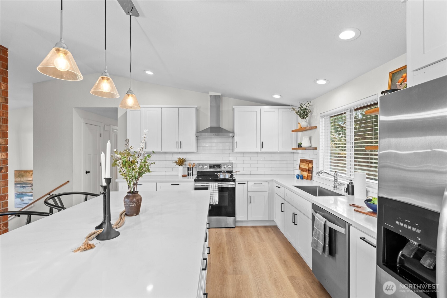 30013 2nd Avenue Southwest Federal Way, WA 98023 - Photo 13 of 40 a kitchen with stainless steel appliances kitchen island granite countertop a sink a stove top oven a counter space and cabinets