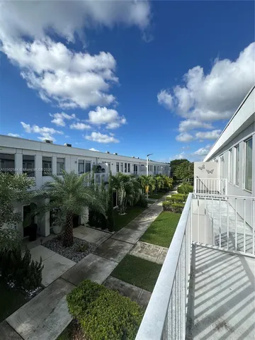 a view of a garden with sitting area