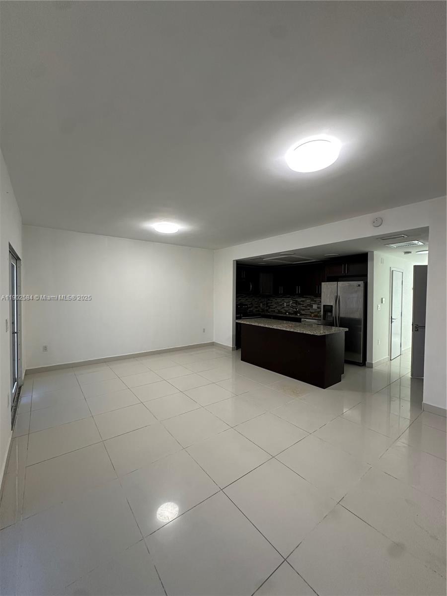 13712 Southwest 259th Street Homestead, FL 33032 - Photo 5 of 8 a living room with a stove and a refrigerator