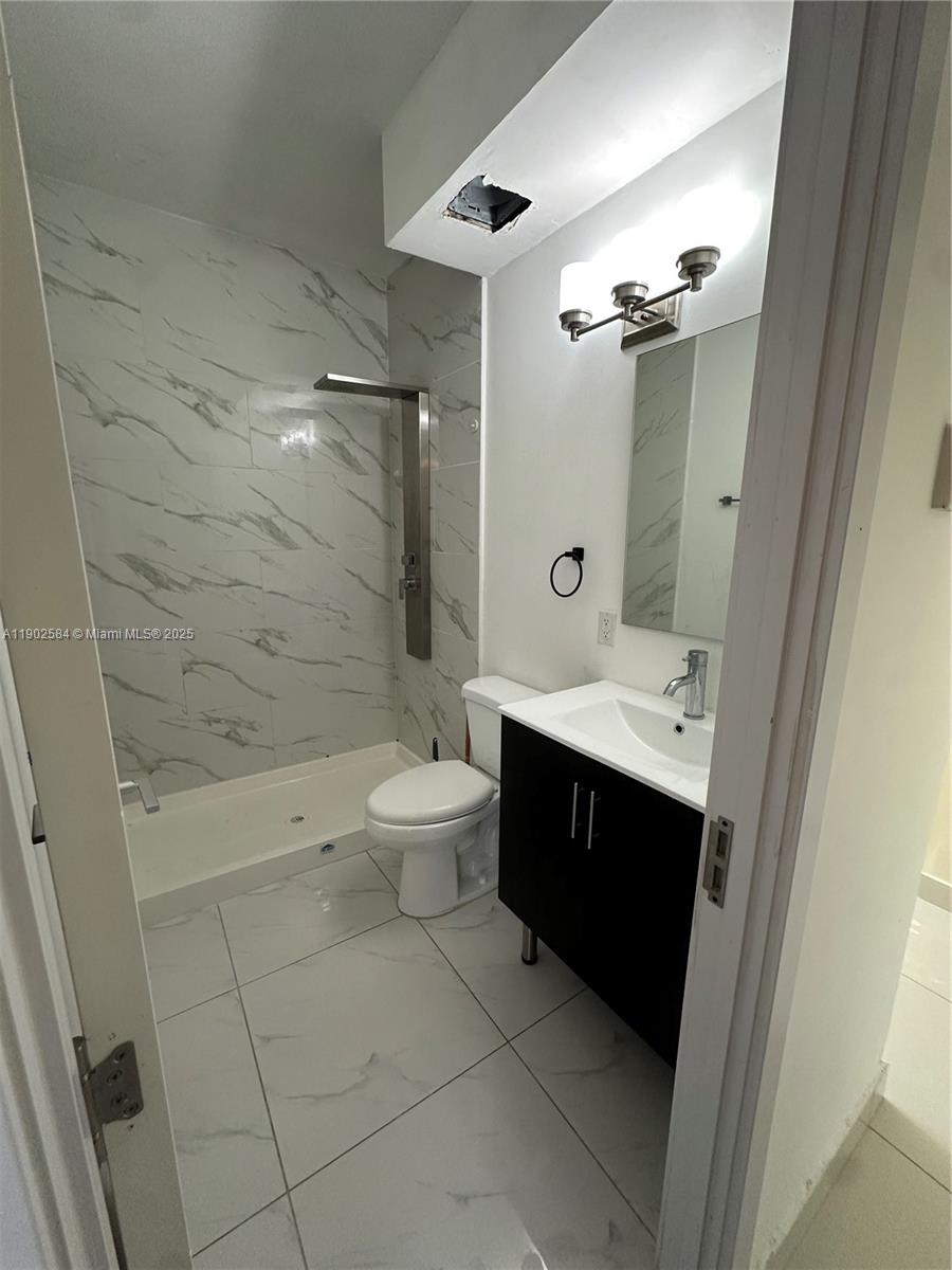 13712 Southwest 259th Street Homestead, FL 33032 - Photo 7 of 8 a bathroom with a sink a toilet and shower