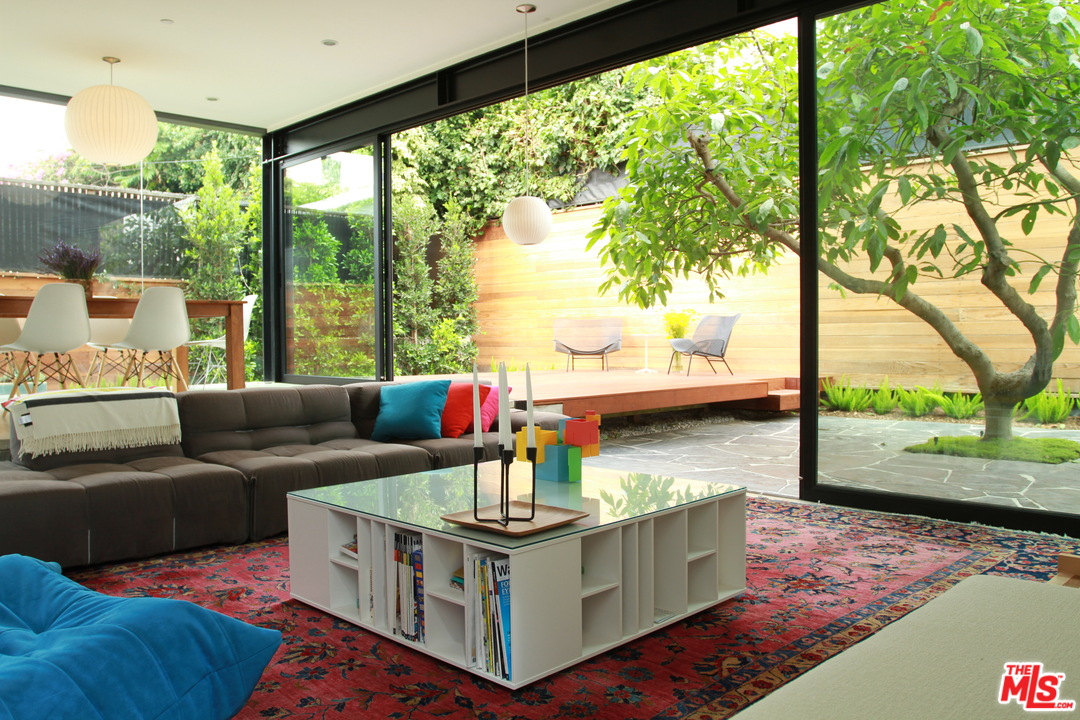 a living room with furniture and a floor to ceiling window
