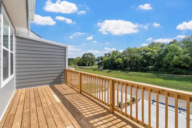 a view of a balcony with wooden floor