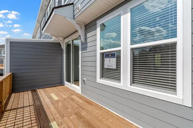 a view of balcony with wooden floor and fence