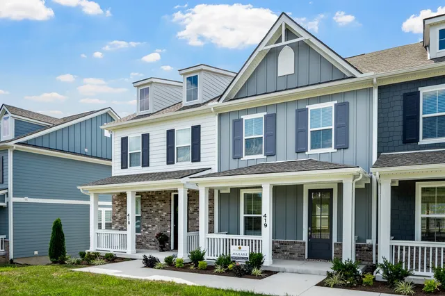 a front view of a house with a garden and plants
