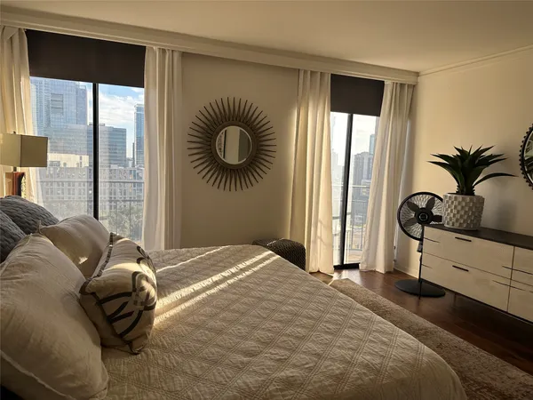 a bedroom with a bed and a large window