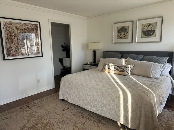 a bedroom with bed and wall painting