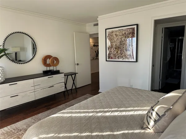 a bedroom with a bed and a dresser