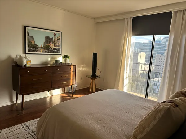 a bedroom with a bed window and a table
