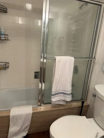 a bathroom with a toilet and a shower