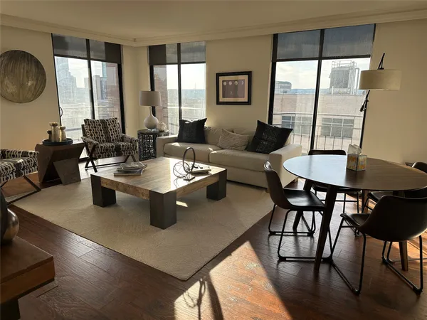 a dining room with furniture and wooden floor