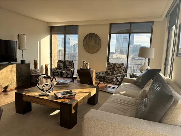 a living room with furniture pool table and flat screen tv