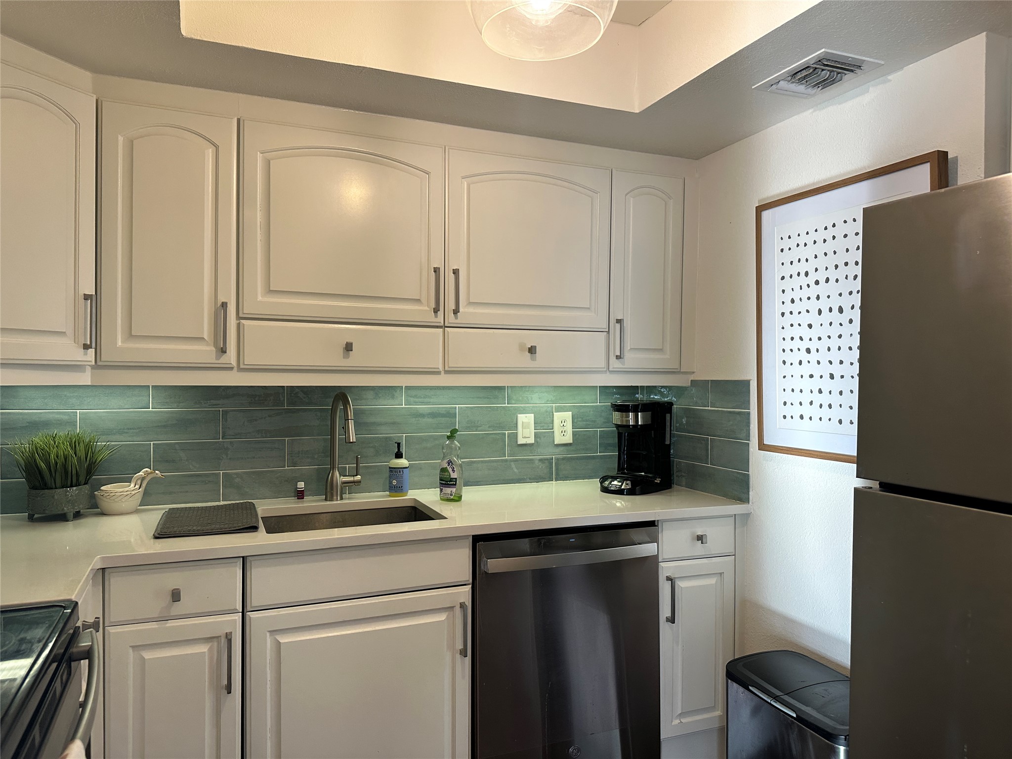 1122 Colorado Street, Unit 1609 Austin, TX 78701 - Photo 7 of 29 a kitchen with stainless steel appliances granite countertop a refrigerator sink and cabinets