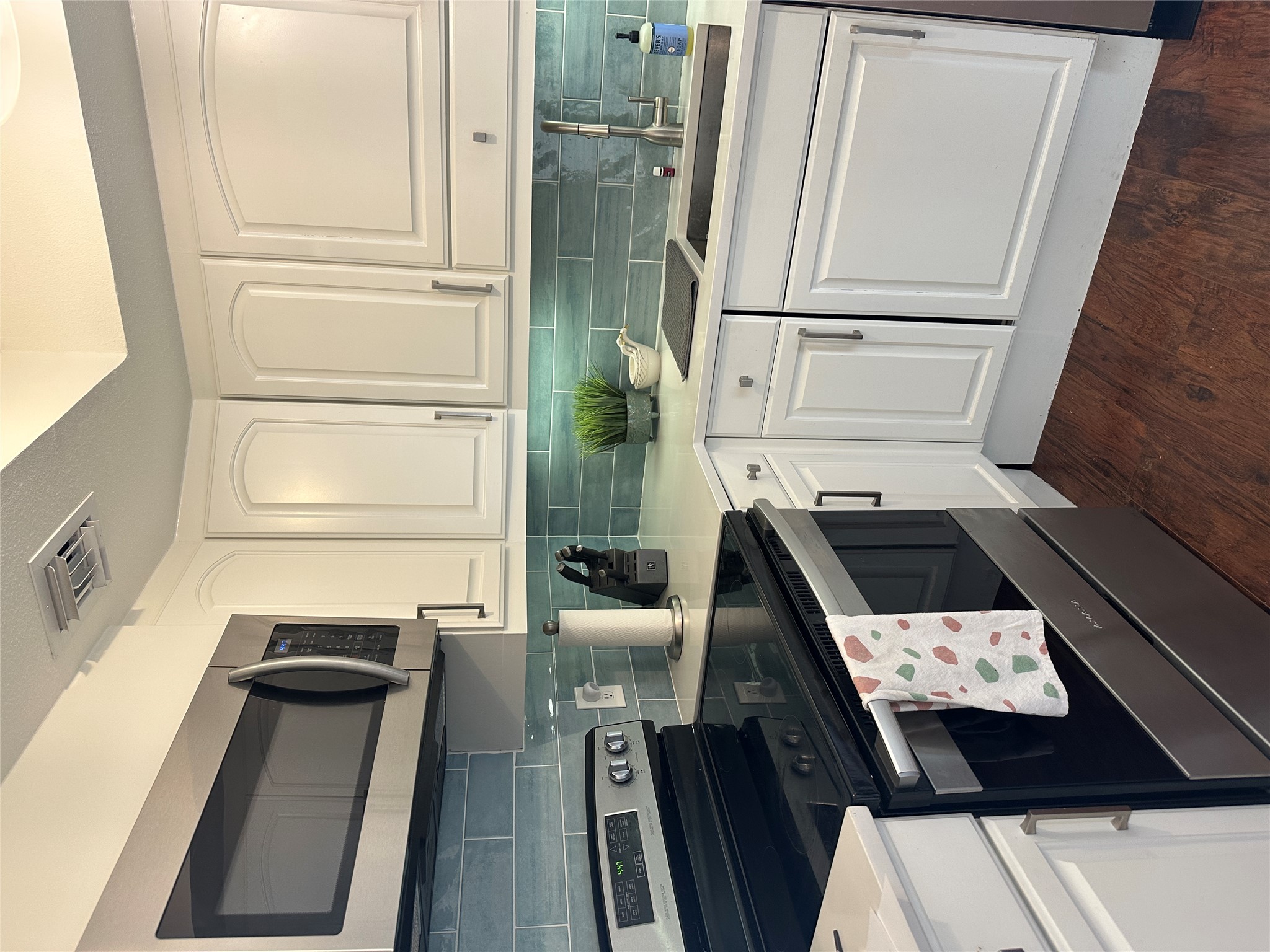 1122 Colorado Street, Unit 1609 Austin, TX 78701 - Photo 8 of 29 a kitchen with stainless steel appliances granite countertop white cabinets a sink and dishwasher