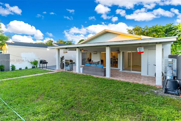 a view of a house with porch and garden