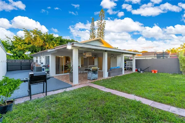 a view of a house with a backyard porch and sitting area