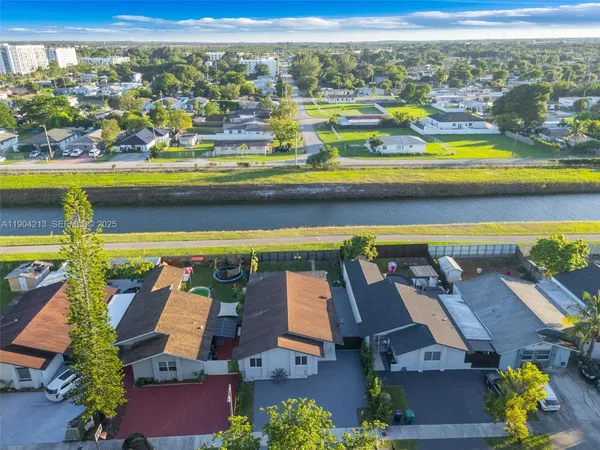 an aerial view of residential houses with outdoor space