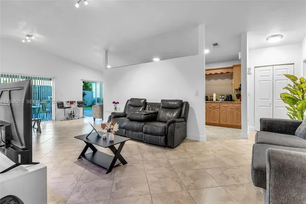 a living room with furniture and a flat screen tv