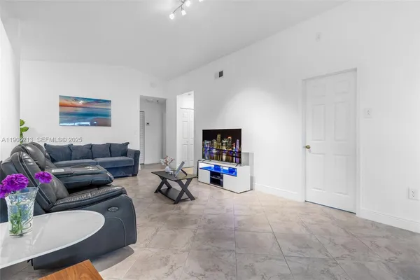 a living room with furniture and a flat screen tv