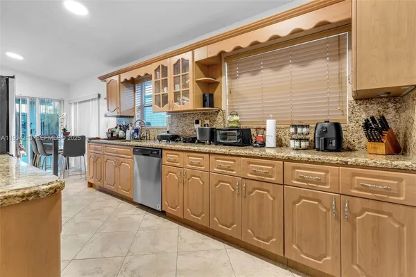 a kitchen with cabinets a sink and appliances