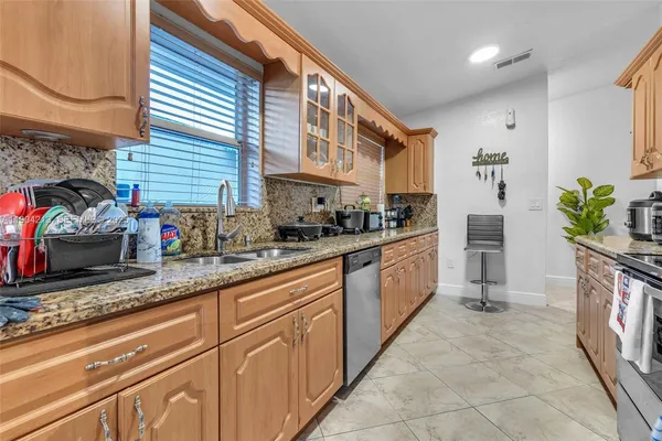 a kitchen with sink cabinets and window