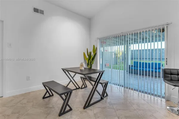 a view of a livingroom with furniture and floor to ceiling window