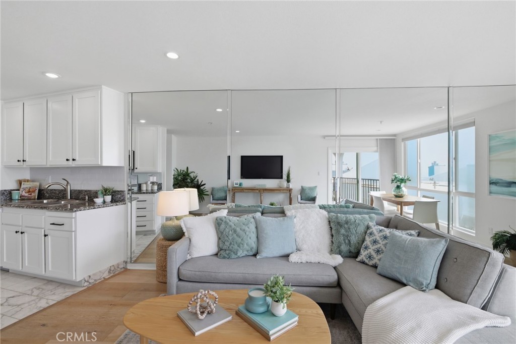565 Esplanade, Unit 312 Redondo Beach, CA 90277 - Photo 12 of 32 a living room with furniture and a flat screen tv