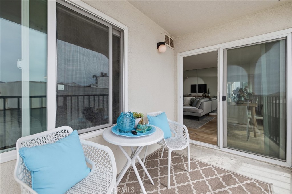 565 Esplanade, Unit 312 Redondo Beach, CA 90277 - Photo 14 of 32 a living room with furniture and a glass door