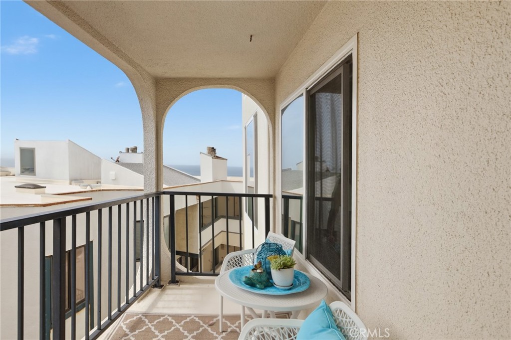 565 Esplanade, Unit 312 Redondo Beach, CA 90277 - Photo 2 of 32 a view of a balcony with chair and potted plants