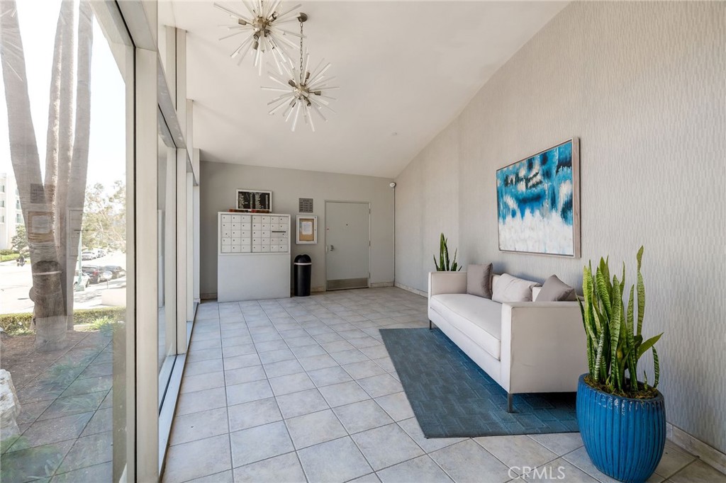 565 Esplanade, Unit 312 Redondo Beach, CA 90277 - Photo 29 of 32 a living room with furniture and a chandelier