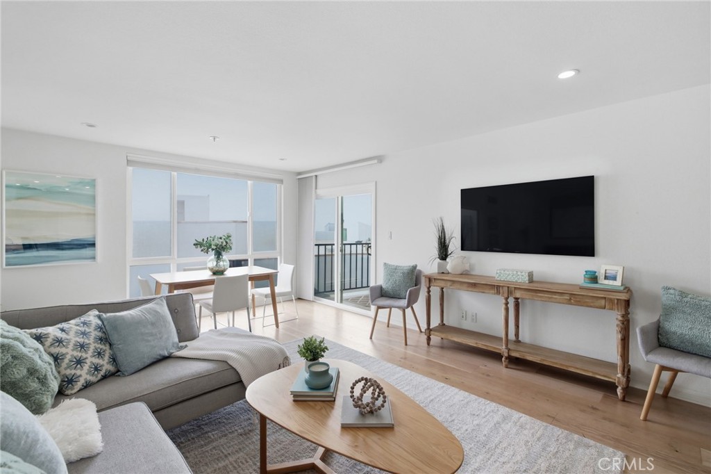565 Esplanade, Unit 312 Redondo Beach, CA 90277 - Photo 3 of 32 a living room with furniture and a flat screen tv