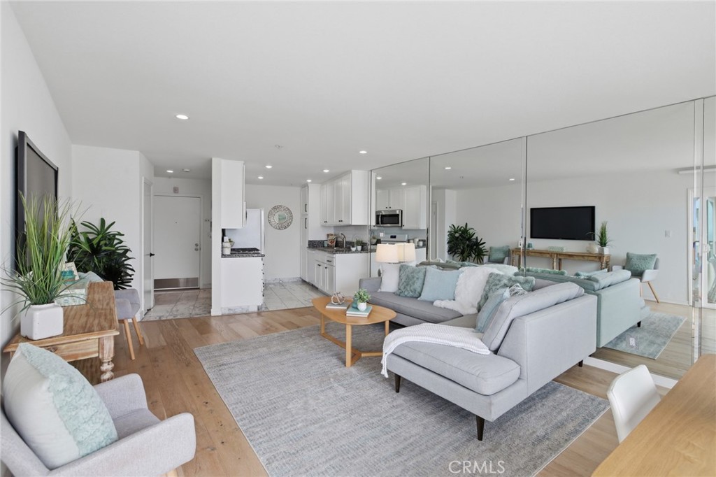 565 Esplanade, Unit 312 Redondo Beach, CA 90277 - Photo 5 of 32 a living room with furniture and a flat screen tv