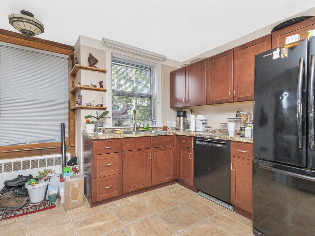 90 Addington Road, Unit 1 Brookline, MA 02445 - Photo 11 of 41 a kitchen with stainless steel appliances granite countertop a refrigerator and a sink