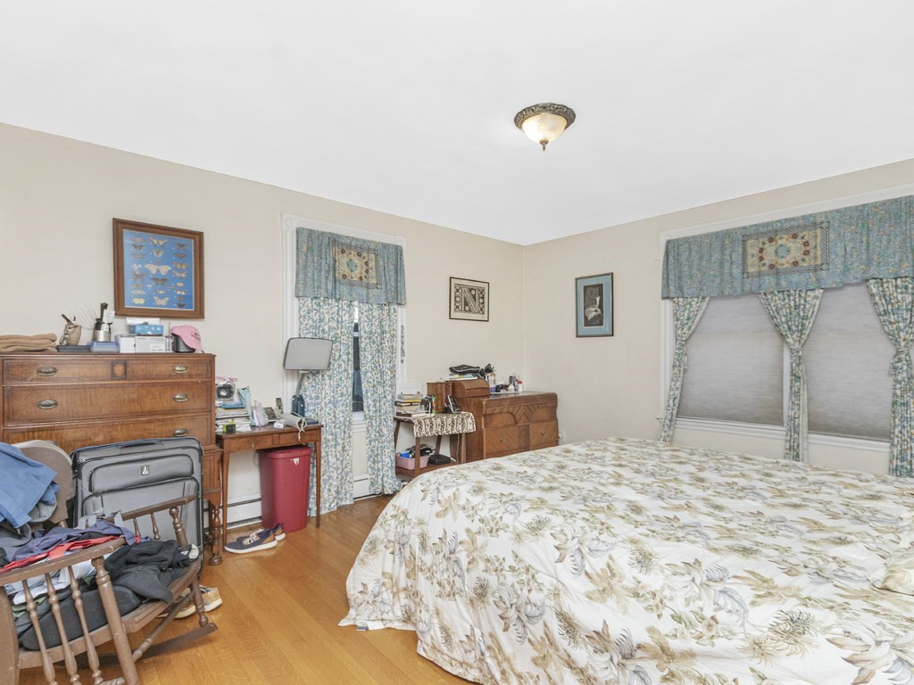 90 Addington Road, Unit 1 Brookline, MA 02445 - Photo 12 of 41 a bedroom with a bed and wooden floor