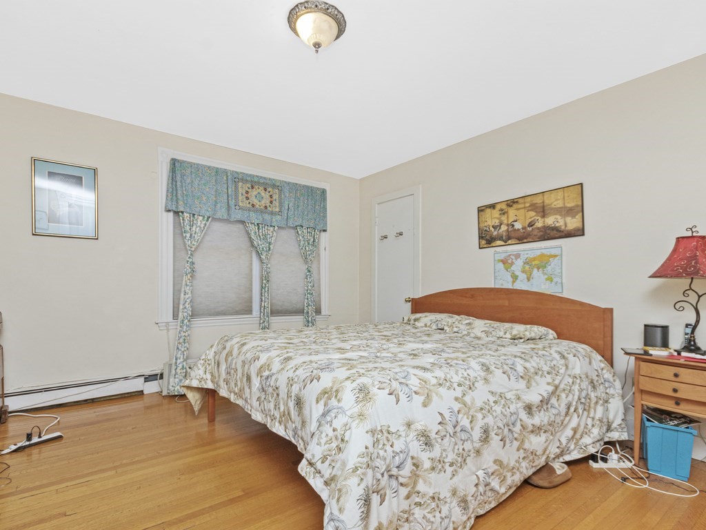 90 Addington Road, Unit 1 Brookline, MA 02445 - Photo 13 of 41 a bedroom with a bed and lamp