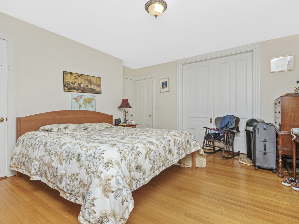 90 Addington Road, Unit 1 Brookline, MA 02445 - Photo 14 of 41 a bedroom with a bed and wooden floor