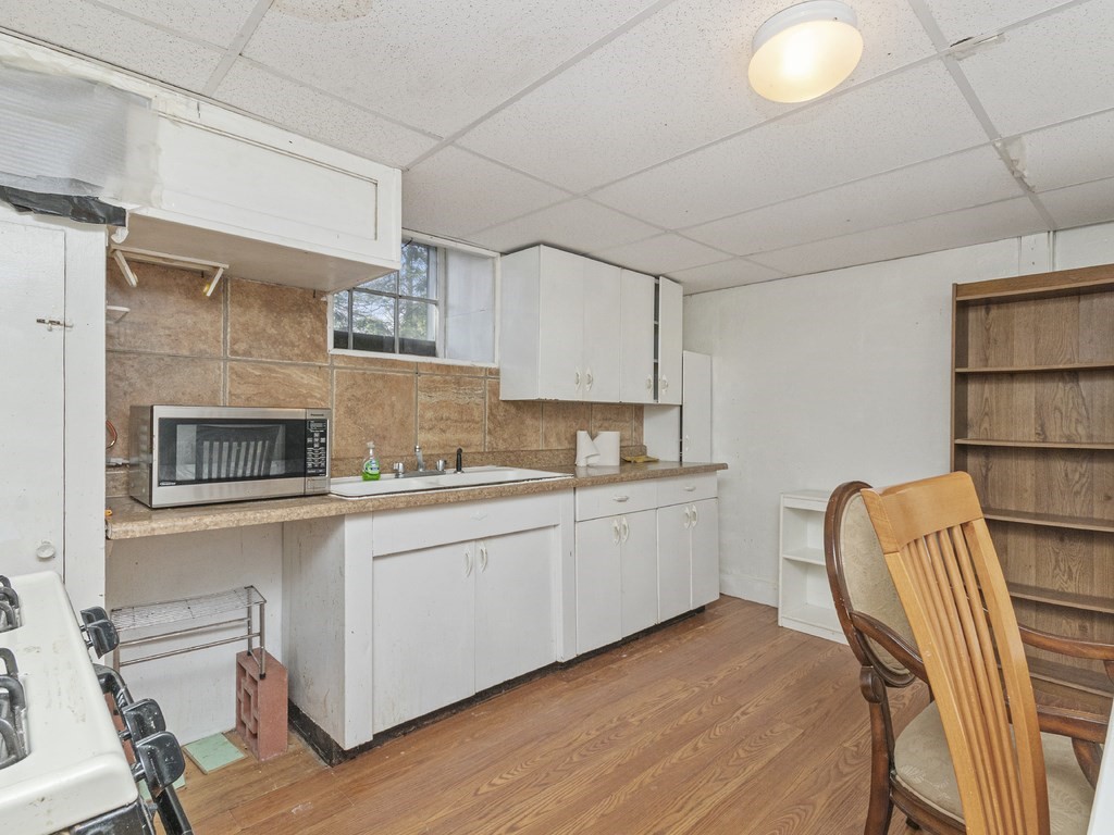 90 Addington Road, Unit 1 Brookline, MA 02445 - Photo 28 of 41 a kitchen with stainless steel appliances granite countertop a sink and cabinets