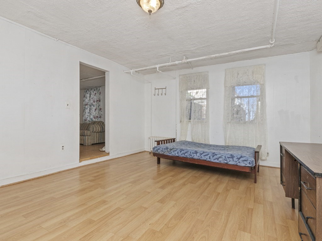 90 Addington Road, Unit 1 Brookline, MA 02445 - Photo 32 of 41 a bedroom with a bed and a wooden floor