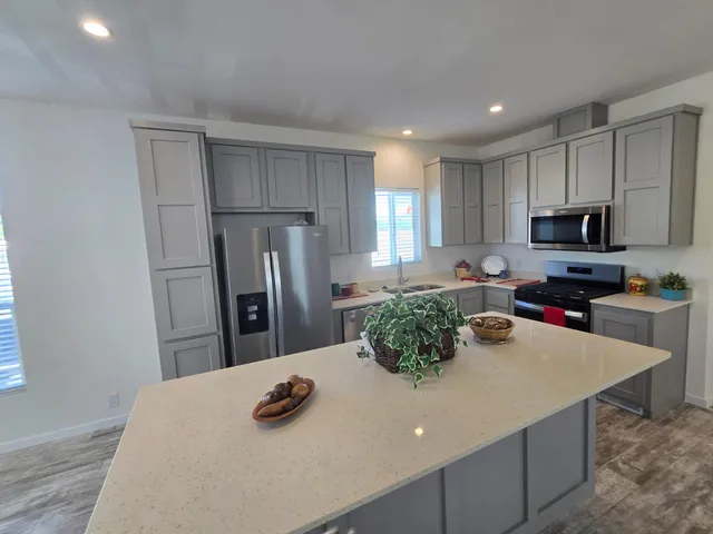 a kitchen with refrigerator and microwave