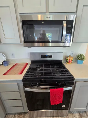 a stove top oven sitting inside of a kitchen