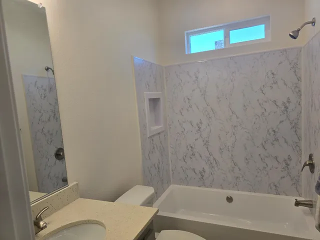 a bathroom with a bathtub and shower