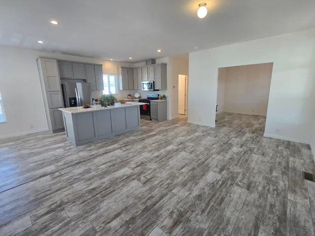 a view of kitchen and kitchen with furniture wooden floor