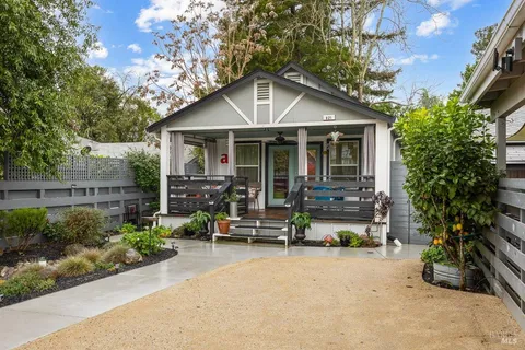a view of a house with backyard sitting area and garden